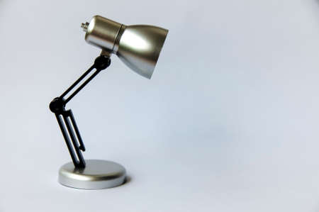 Closeup silver and black small lamp with white cover background. Copy spaceの写真素材