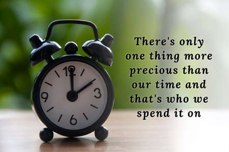 Inspirational quote text with black alarm clock background. The clock set at 2 o'clock, Motivational conceptの写真素材