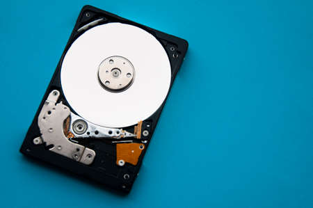 The abstract image of inside of hard disk drive on blue cover background. Concept of data, hardware, and information technology. Copy spaceの写真素材