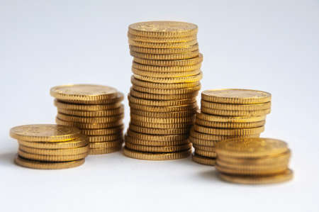 Gold coins stacked on white background. Finance and copy space conceptの写真素材