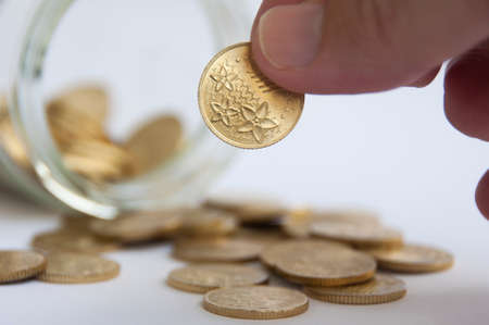 Hand holding gold coin. Business and finance conceptの写真素材