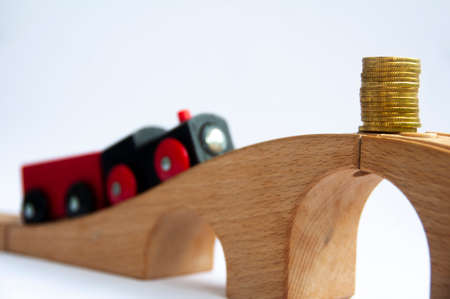 Wooden toy train heading to gold coins. Conceptualの写真素材