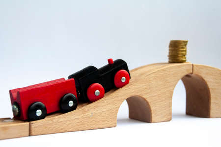 Wooden toy train heading to gold coins. Conceptualの写真素材