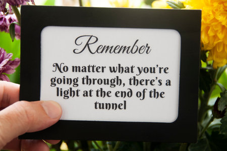 Motivational quote text on notepad - No matter what you're going through, there's a light at the end of the tunnel. Motivational conceptの写真素材