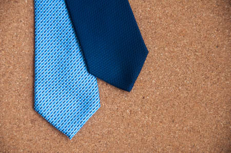Blue neckties on wooden background. Copy space