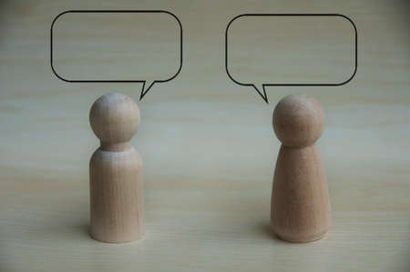 Wooden dolls with speech bubble chatting. Interaction and chat conceptの写真素材