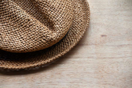 Travelling brown hat on wooden desk. Copy space