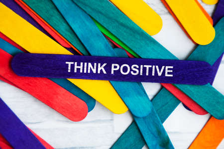 Think positive text on blue wooden stick. Motivational conceptの写真素材