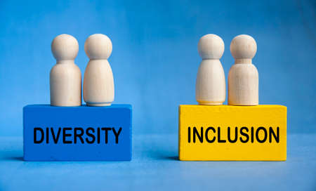 Diversity and inclusion text on wooden blocks with wooden dolls. Togetherness conceptの写真素材