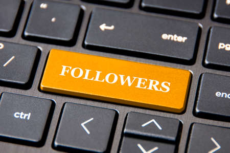 Online business concept - Laptop keyboard with yellow Followers button.の写真素材