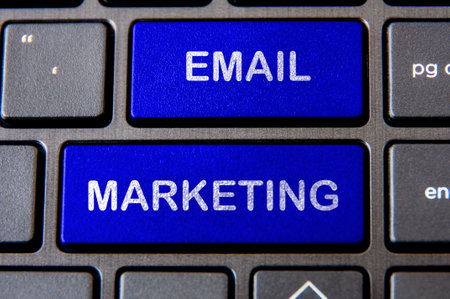 Online business concept - Laptop keyboard with blue Email Marketing button.の写真素材