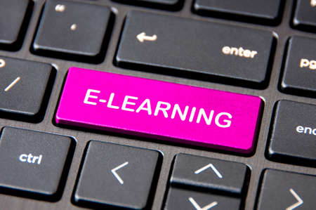 E-learning concept - Laptop keyboard with pink E-Learning button.の写真素材