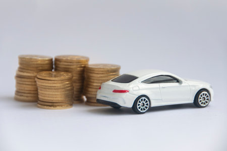 Kuala Lumpur, Malaysia - April 2022 : Miniature toy car of Mercedes AMG with gold coin background. Copy spaceのeditorial素材