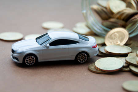 Kuala Lumpur, Malaysia - April 2022 : Miniature toy car of Mercedes AMG with gold coin background. Copy spaceのeditorial素材