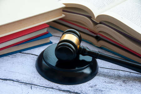 Lawyer gavel on wooden table with books background. Law conceptの写真素材