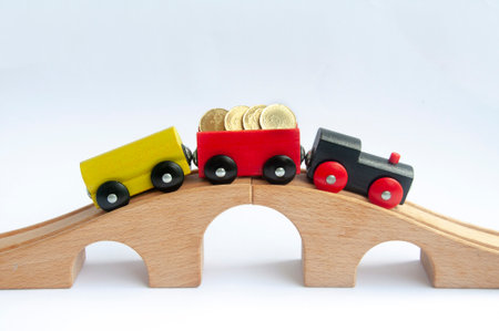 Wooden toy train with gold coins. Conceptualの写真素材