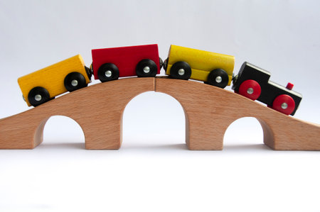 Wooden toy train crossing track bridge. Conceptualの写真素材