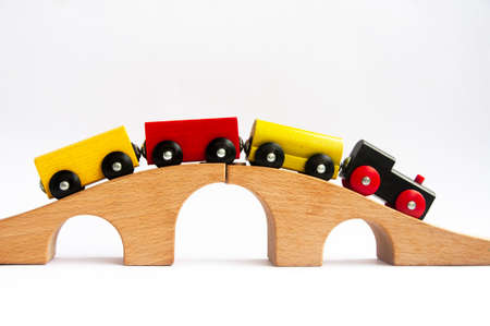 Wooden toy train crossing track bridge. Conceptualの写真素材
