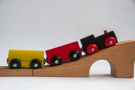 Wooden toy train crossing track bridge. Conceptualの写真素材