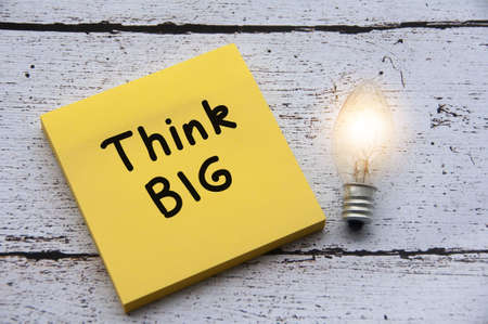 Think Big Text and Light Bulb on Paper Note. Business conceptの写真素材
