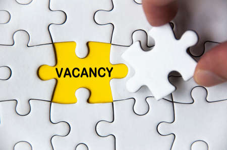 Vacancy text on missing jigsaw puzzle. Employment conceptの写真素材