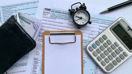 Blank white notepad on tax form. Copy spaceの写真素材