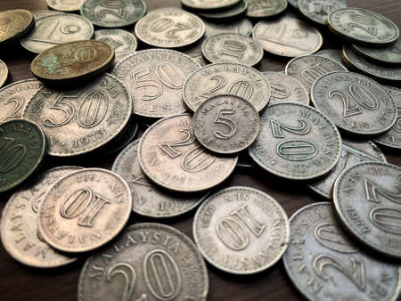 Isolated old coin on brown wooden table.の写真素材