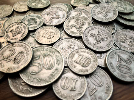 Isolated old coin on brown wooden table.の写真素材