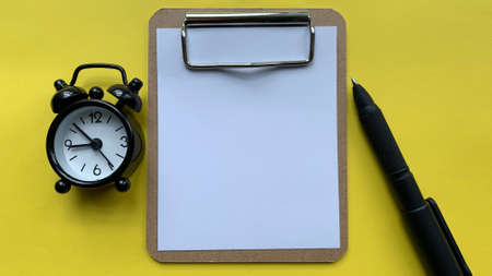 Top view of blank notepad with yellow background. Copy space