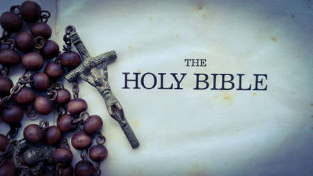 Top view of Holy Bible text with Rosary on old Bible. Christianity and vintage conceptの写真素材