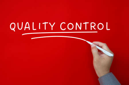 Quality control text on red cover background. Business conceptの写真素材