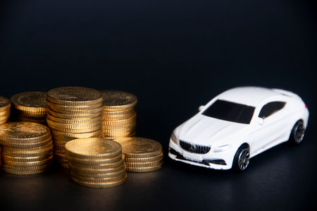Kuala Lumpur, Malaysia - July 2022 : Miniature toy car of Mercedes AMG with gold coins on black cover background. Copy spaceのeditorial素材