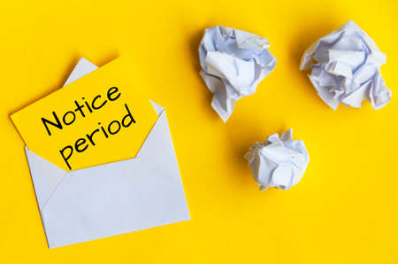 Notice period text on yellow notepad in an envelope. Employment conceptの写真素材