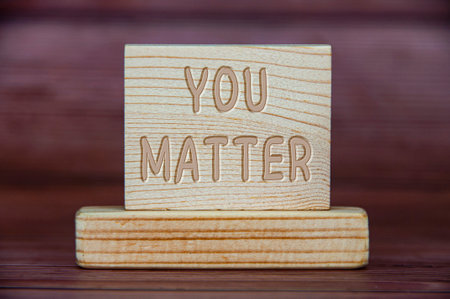 You matter text engraved on wooden block. Inspirational concept.