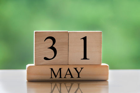 May 31 calendar date text on wooden blocks with blurred nature background. Copy space and calendar concept.の写真素材