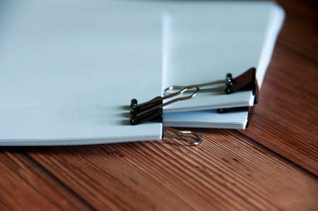 Paper stack of pile of documents on wooden desk. Copy space and business offices concept