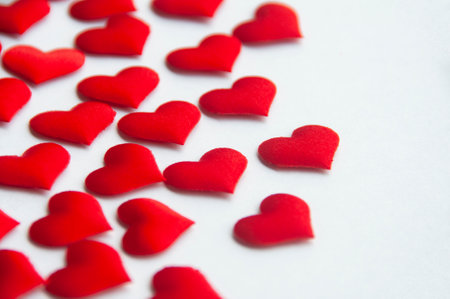 Red heart shapes on white background customizable with space for text. Copy space and relationship...