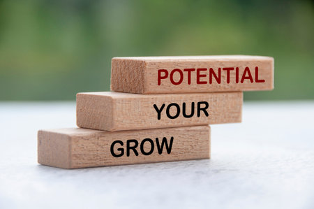 Grow your potential text on stacked wooden blocks with blurred nature background. Motivational conceptの写真素材
