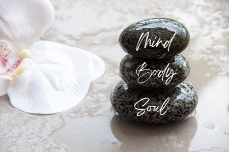 Mind, Body and Soul words engraved on stones. Healthy life concept.