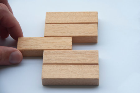 hand placing a wooden block with customizable space for text or ideas. Copy spaceの写真素材