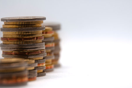 Close up of coins on white background with customizable space for text or ideas. Business and investment concept.の写真素材