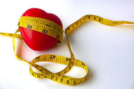 Heart shape wrapped with measuring tap with customizable space for text. Copy space and weight loss...