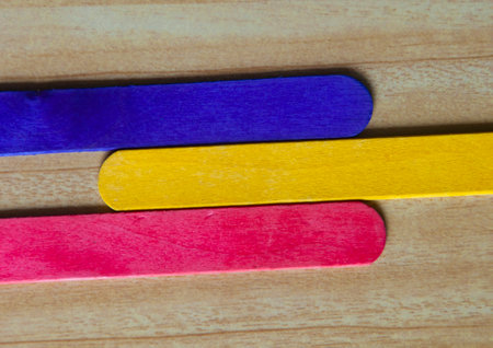 Top view of colored wooden sticks with customizable space for text. Copy space.