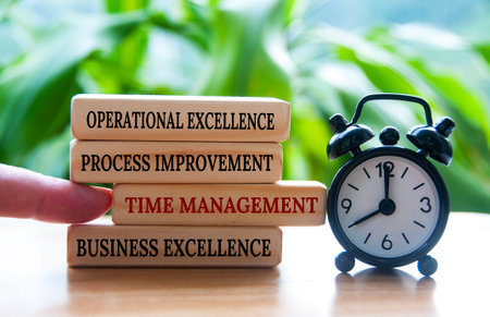 Business concept of time management and operational excellence text on wooden blocksの写真素材
