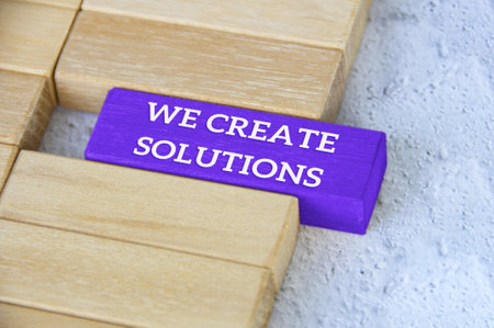 Top view of text - we create solutions text on blue wooden block separated from the rest of the...