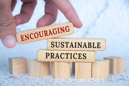 Encouraging sustainable practices text on wooden blocks. Conservation and nature concept.の写真素材