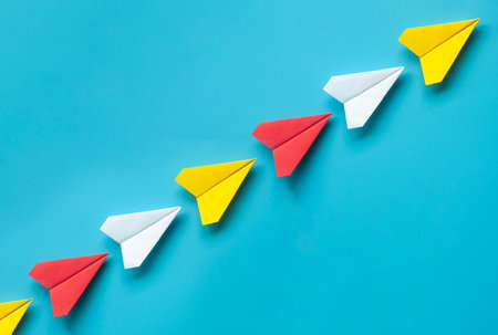 Top view of red, white and yellow paper on blue background.の写真素材