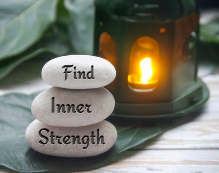Find inner strength words engraved on zen stones. Motivational concept.の写真素材
