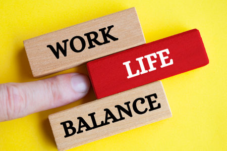 Work life balance text on wooden blocks with yellow cover background. Working culture conceptの写真素材