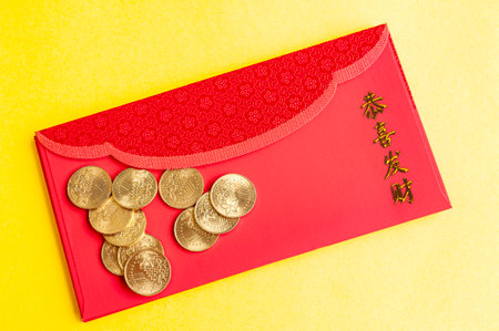 Top view of Chinese New Year red packets on yellow cover background.